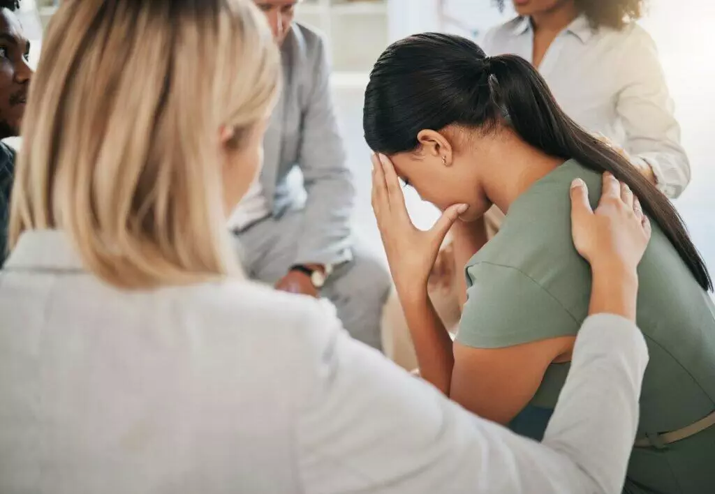 Grief, loss and woman at community support group for mental health, counseling or help