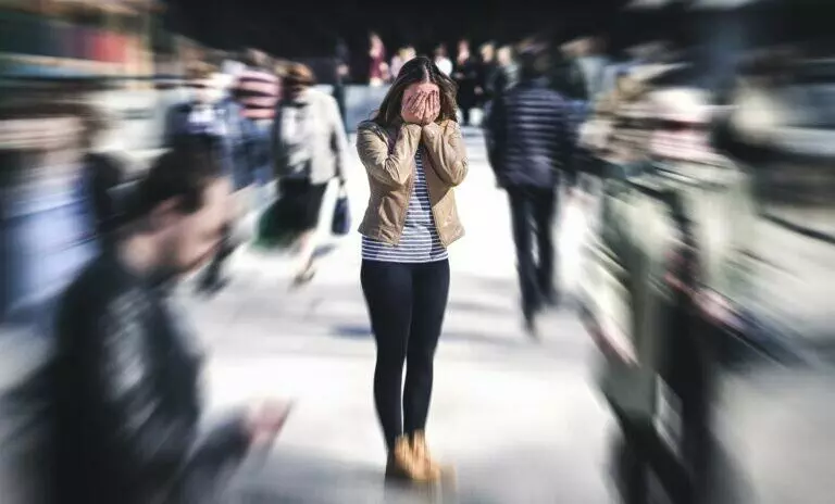 Understanding Agoraphobia. Woman having an anxiety or nervous attack in the middle of a crowd