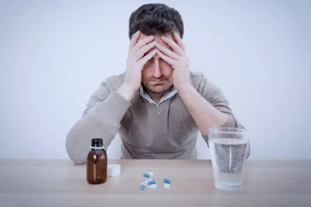 Man fighting stress with antidepressant drugs meds