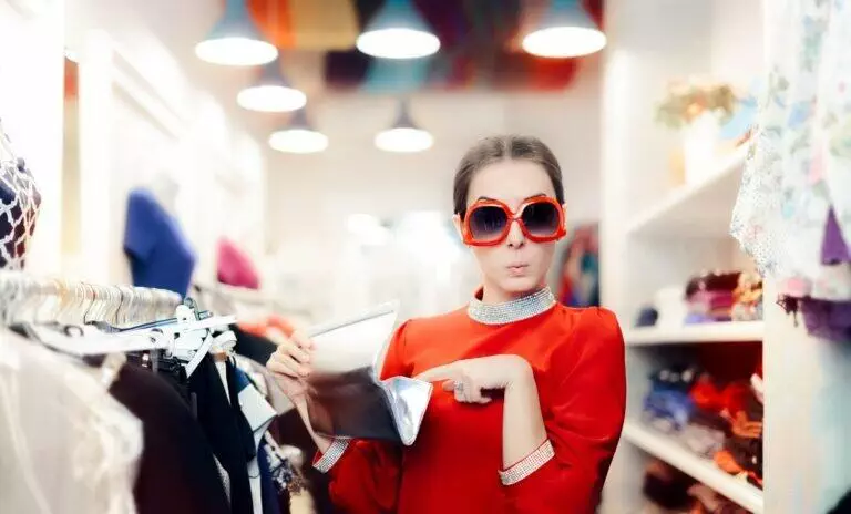 Woman Shopping with Oversized Sunglasses and Silver Clutch Bag