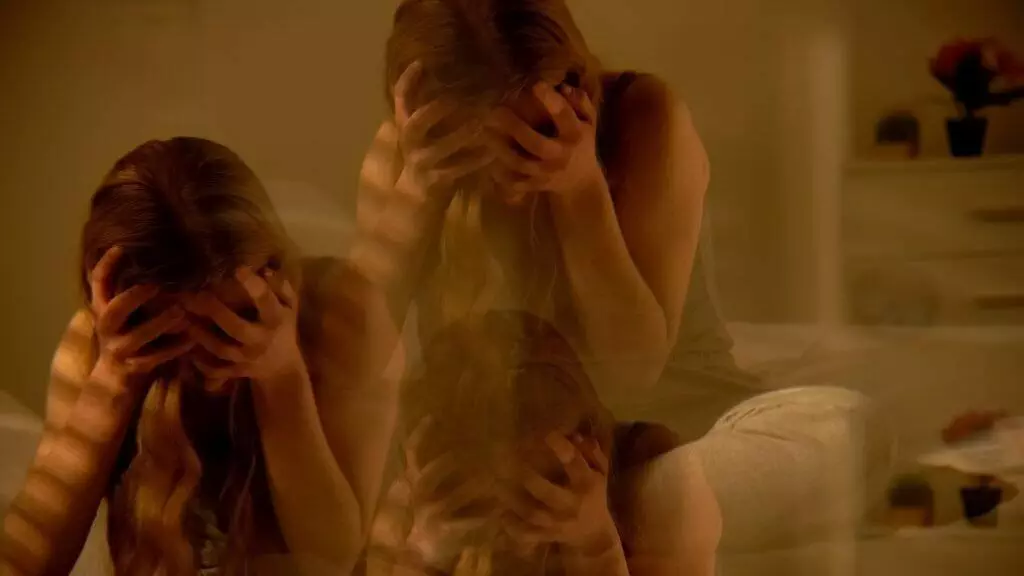 blurred image of traumatized teenage girl inside a room